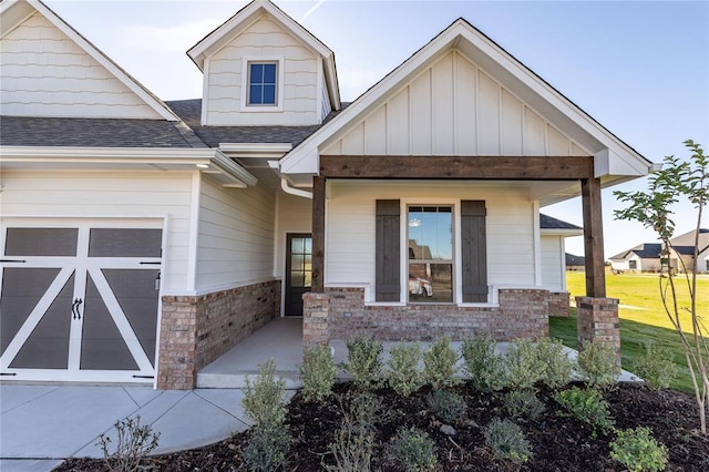 exterior space featuring a front lawn, a porch, and a garage