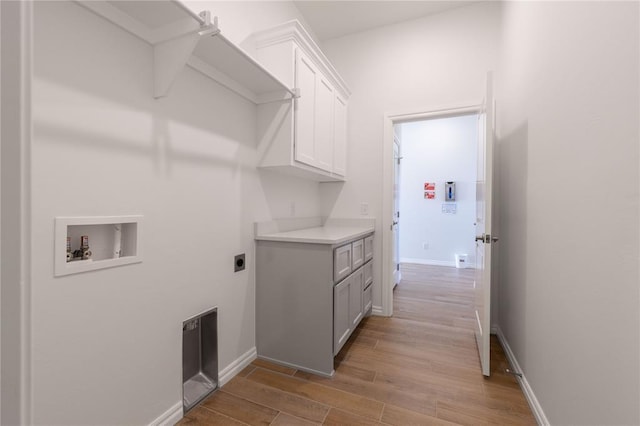 laundry area with cabinets, washer hookup, light hardwood / wood-style flooring, and hookup for an electric dryer