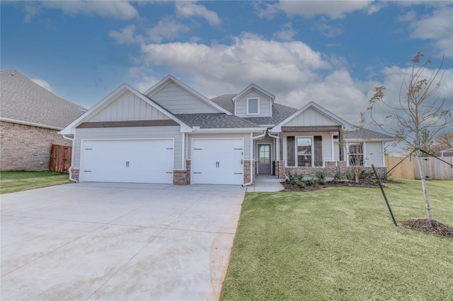 craftsman-style home featuring a front yard and a garage