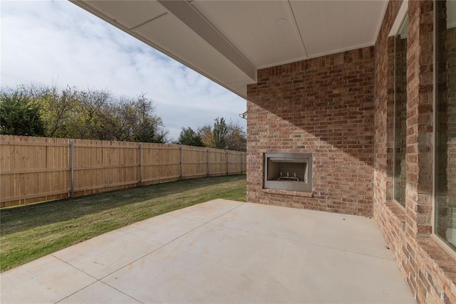 view of patio / terrace with an outdoor brick fireplace