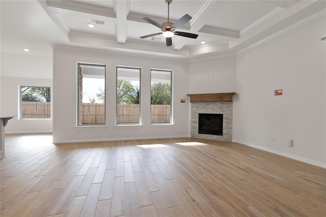 unfurnished living room with a stone fireplace, light hardwood / wood-style floors, and ornamental molding