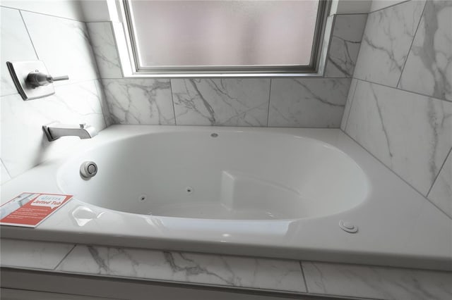 bathroom with a relaxing tiled tub