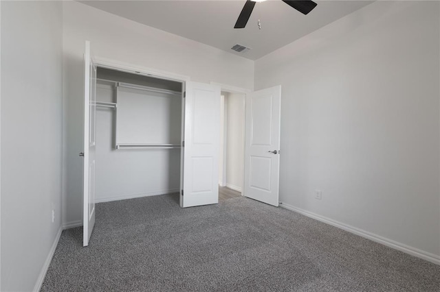 unfurnished bedroom featuring a closet, dark carpet, and ceiling fan