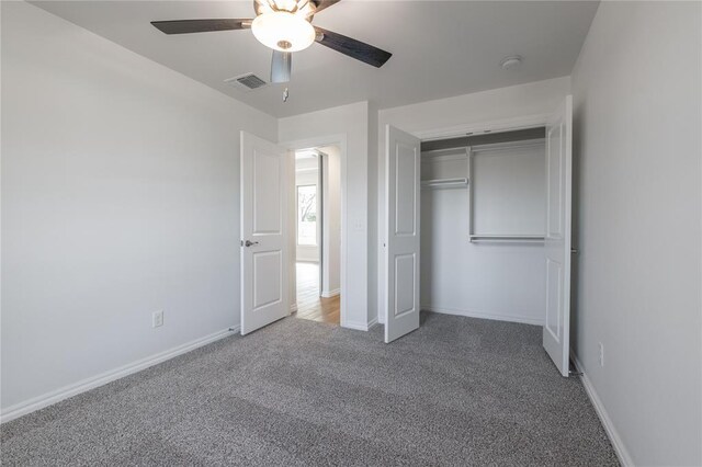 unfurnished bedroom with carpet, ceiling fan, and a closet