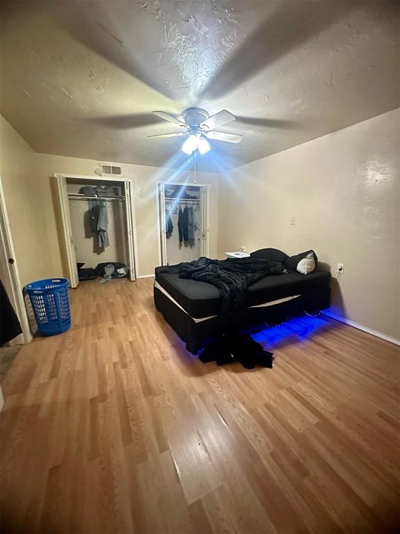 bedroom featuring hardwood / wood-style flooring and ceiling fan