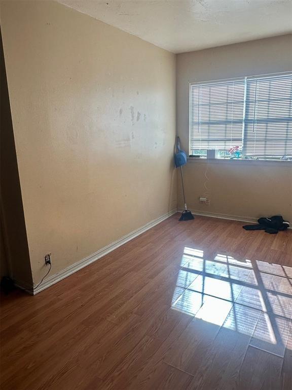 unfurnished room featuring hardwood / wood-style flooring