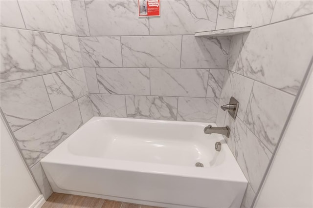 bathroom featuring hardwood / wood-style floors and a bath