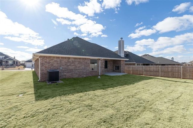 back of house with a patio, central AC unit, and a lawn