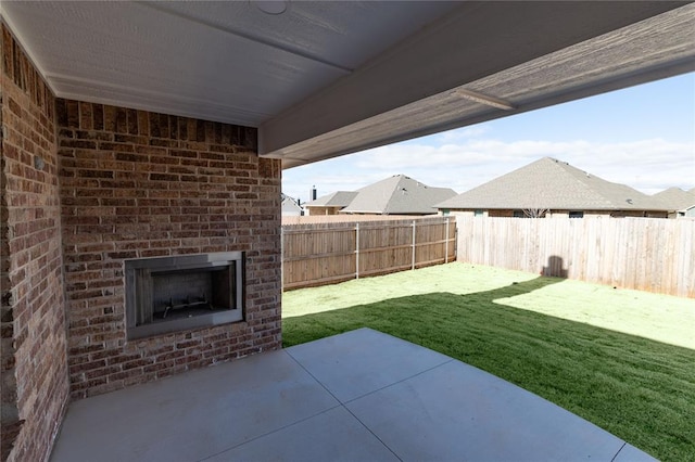 view of patio / terrace featuring an outdoor brick fireplace