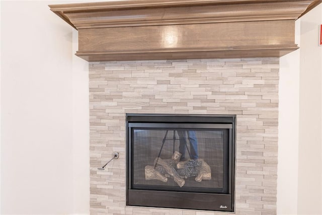 interior details with a tile fireplace