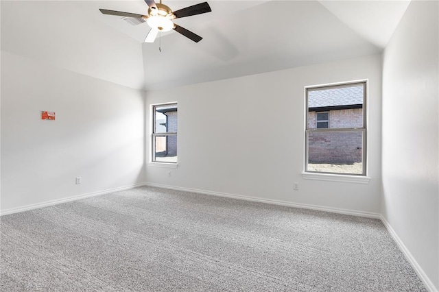 spare room with carpet flooring, ceiling fan, and vaulted ceiling