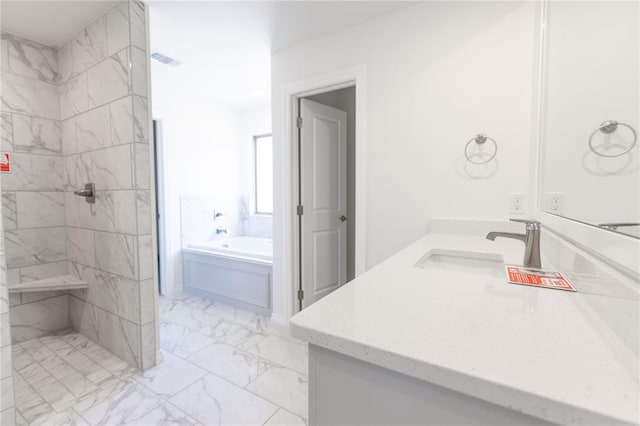 bathroom featuring vanity and separate shower and tub