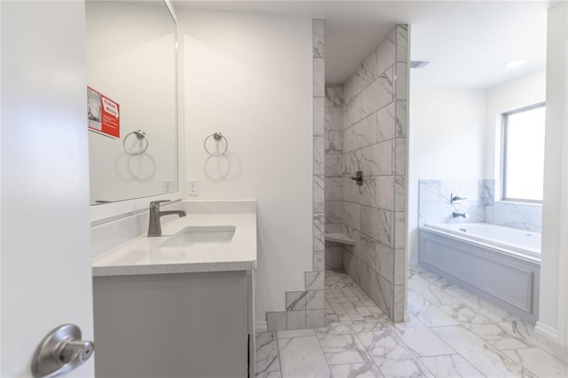 bathroom featuring vanity and shower with separate bathtub