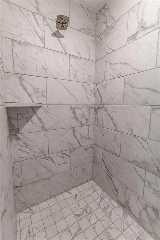 bathroom with a tile shower