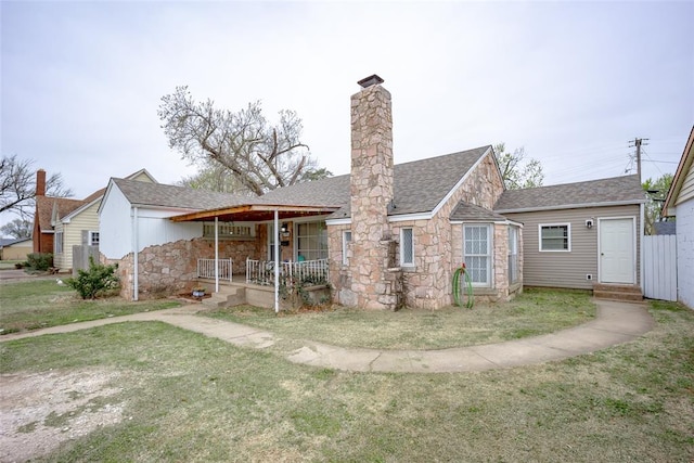 back of house with a porch and a yard