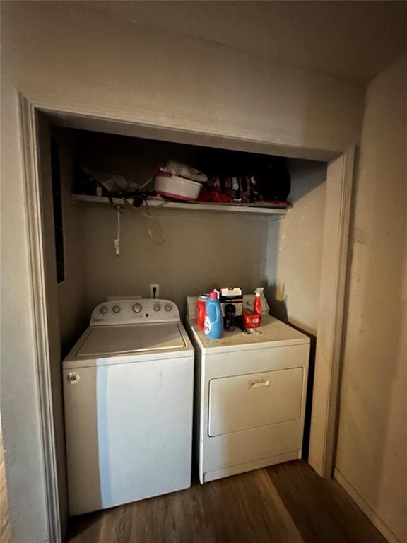 laundry area with laundry area, separate washer and dryer, and dark wood-style flooring