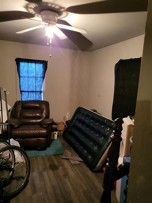 sitting room featuring a ceiling fan and wood finished floors