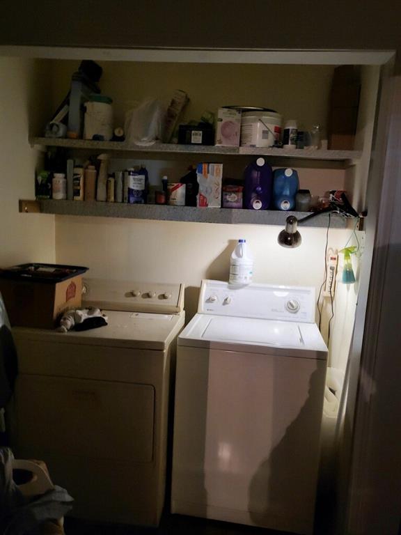 laundry area with washing machine and clothes dryer