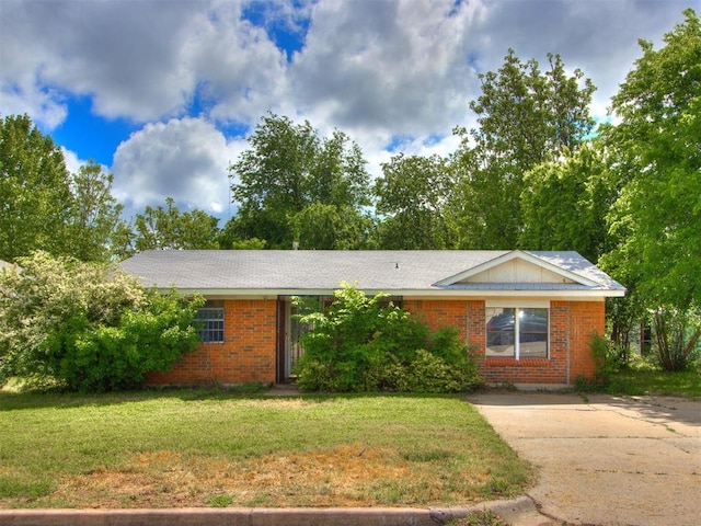 8708 N Hudson Ave, Oklahoma City, OK 73114 - ranch-style home with brick siding, a front yard, and driveway