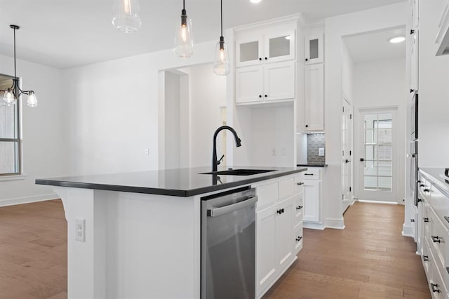 kitchen with dishwasher, a center island with sink, sink, light wood-type flooring, and white cabinetry