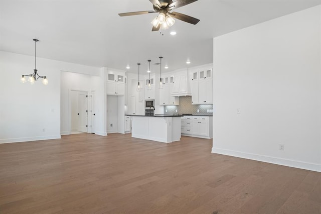 kitchen featuring white cabinets, pendant lighting, and light hardwood / wood-style flooring