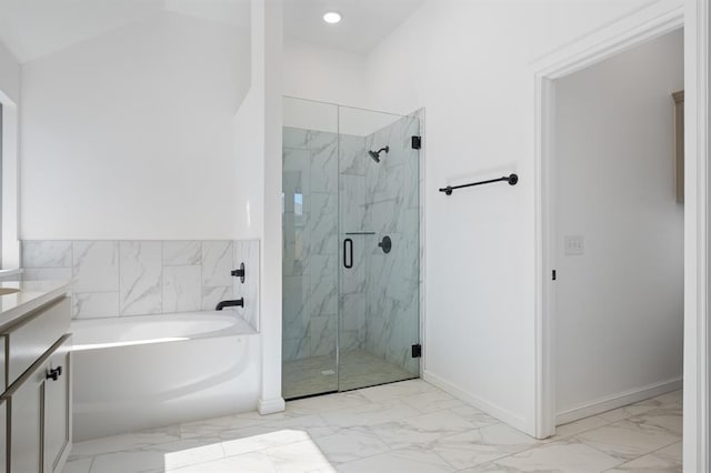 bathroom featuring plus walk in shower, vanity, and vaulted ceiling