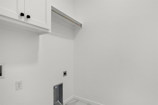 laundry room featuring hookup for an electric dryer and cabinets