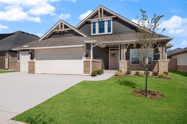 craftsman house with a front yard and a garage