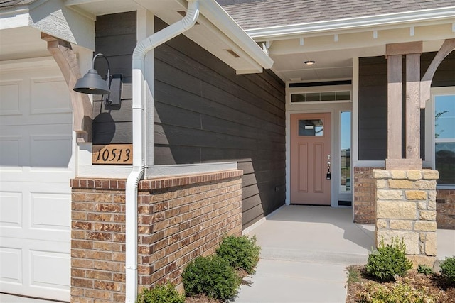 property entrance featuring covered porch and a garage