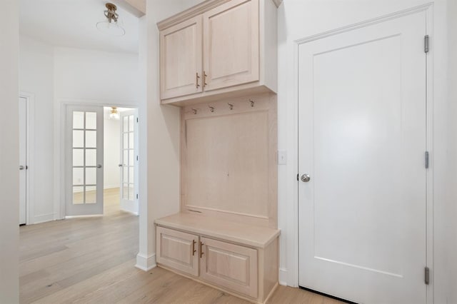 mudroom with light hardwood / wood-style floors