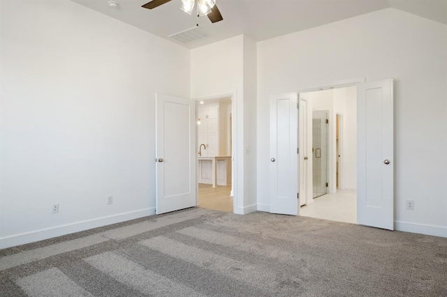 unfurnished bedroom with light carpet, high vaulted ceiling, and ceiling fan