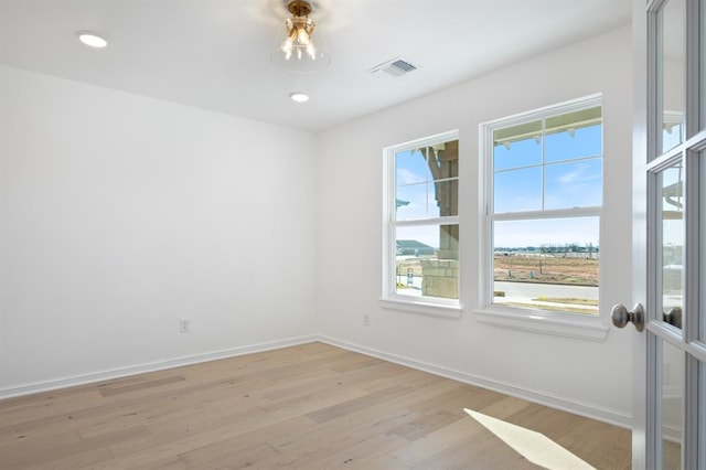 spare room with light wood-type flooring