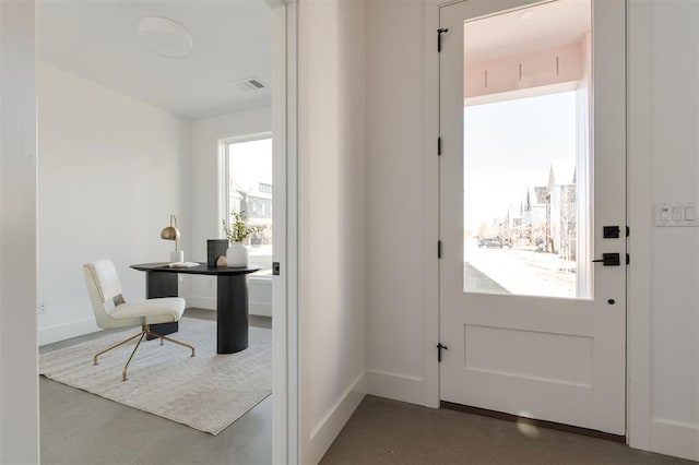 doorway to outside with concrete flooring