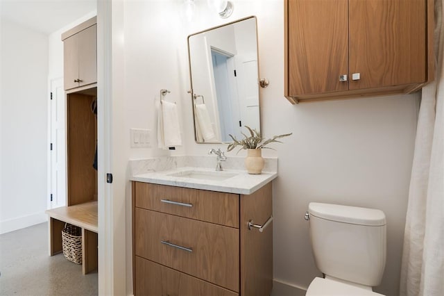 bathroom featuring vanity and toilet