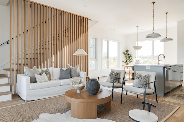 living room with sink and light hardwood / wood-style floors