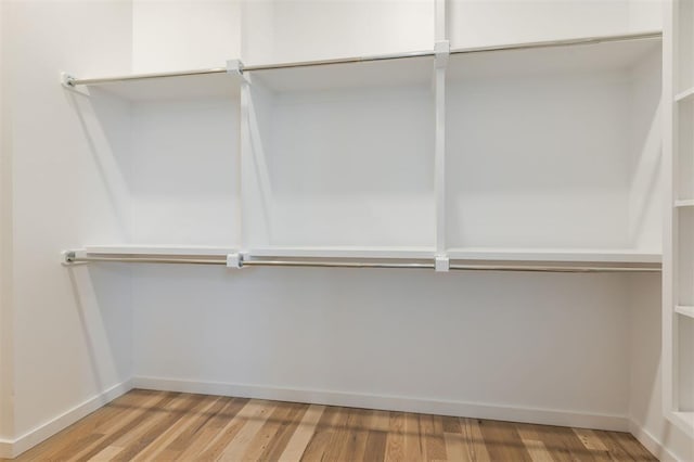 spacious closet featuring hardwood / wood-style floors