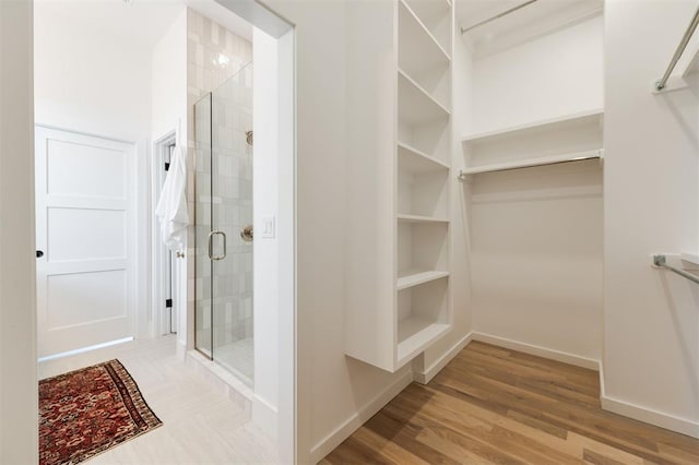 bathroom featuring hardwood / wood-style floors and a shower with shower door