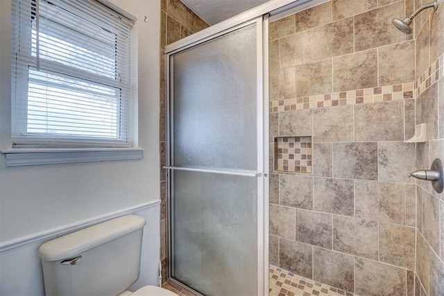 bathroom with toilet and walk in shower