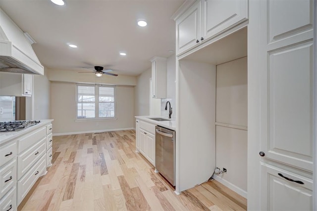 kitchen featuring white cabinetry, ceiling fan, stainless steel appliances, light hardwood / wood-style floors, and custom range hood