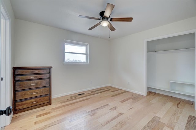 unfurnished bedroom with ceiling fan, a closet, and light wood-type flooring