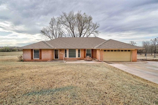 ranch-style home featuring a garage and a front lawn