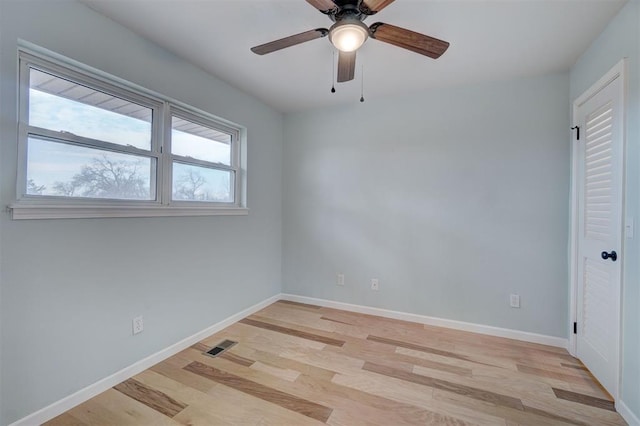 spare room featuring light hardwood / wood-style flooring and ceiling fan