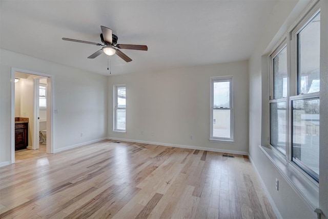 spare room featuring light hardwood / wood-style flooring and ceiling fan