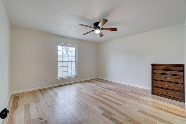 empty room with light hardwood / wood-style floors and ceiling fan