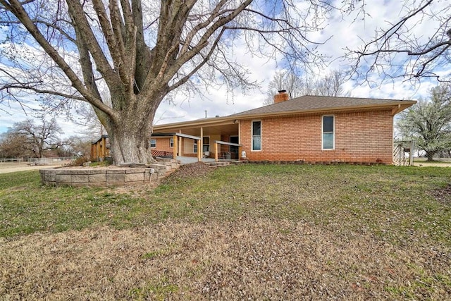 back of house featuring a yard