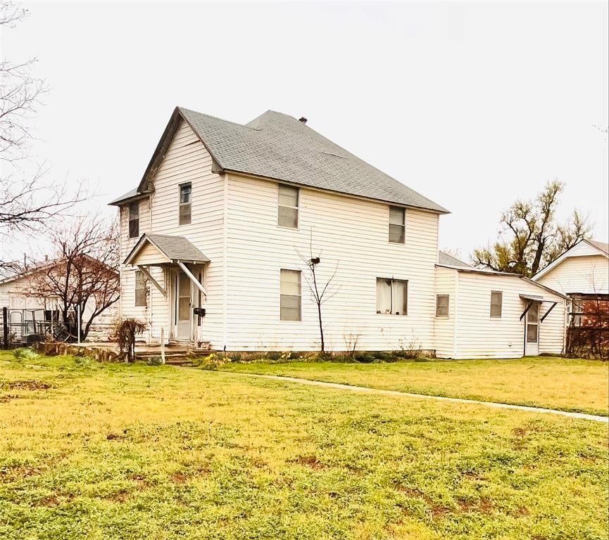 rear view of house with a lawn