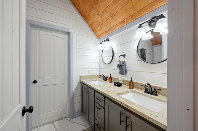 full bath with vaulted ceiling, marble finish floor, wooden ceiling, and a sink