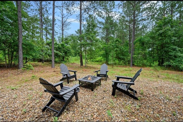 view of yard with a fire pit