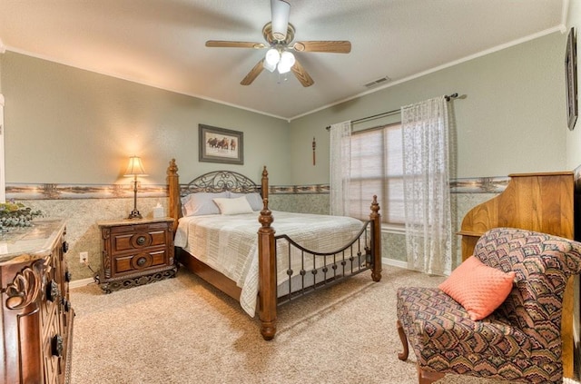 bedroom featuring ceiling fan, ornamental molding, and light carpet