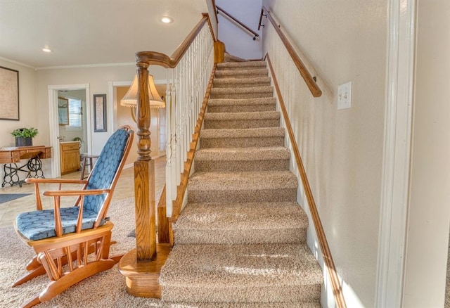 stairs featuring crown molding